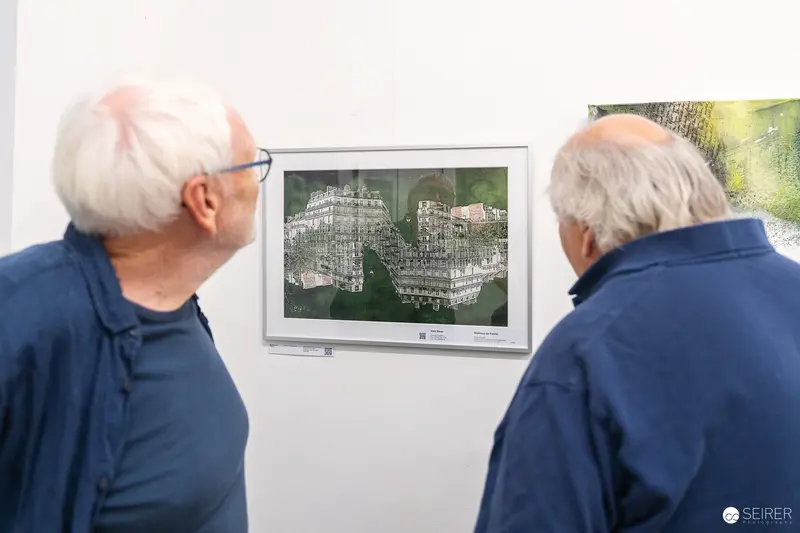 Two Art Enthusiasts Examining Architectural Artwork at Gallery Exhibition