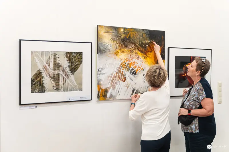 Art Enthusiasts Examining Abstract Paintings at Vernissage "Ladypower"