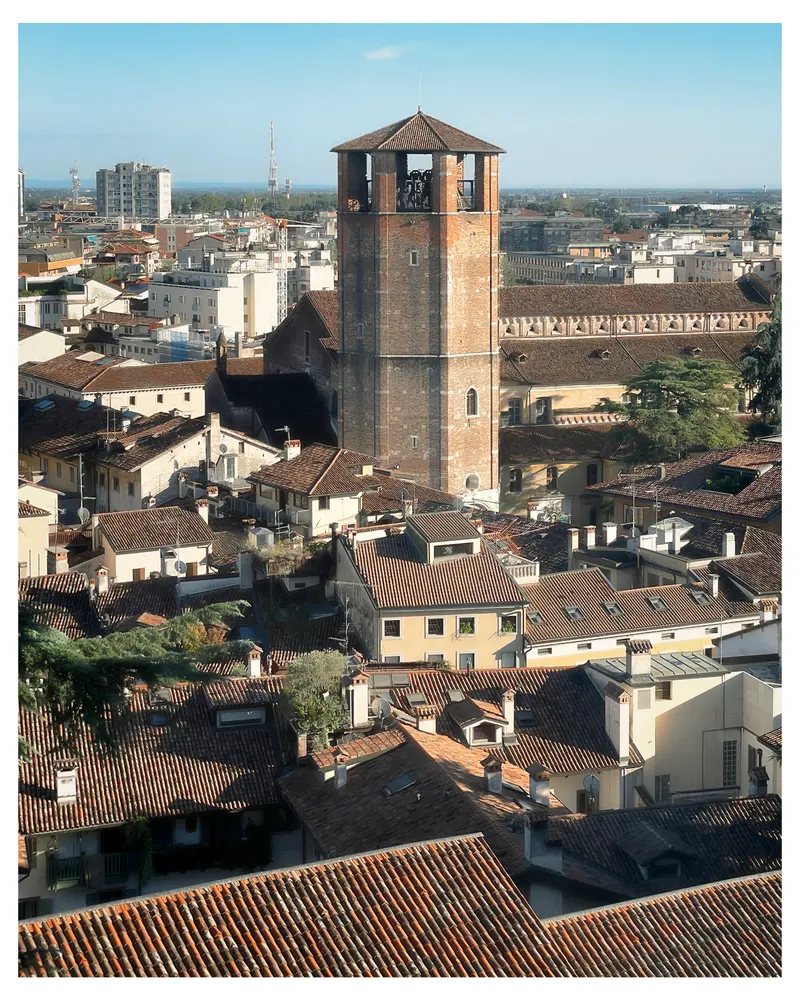 Medieval Stone Tower Overlooking Dense Urban Rooftops in Italian City Landscape