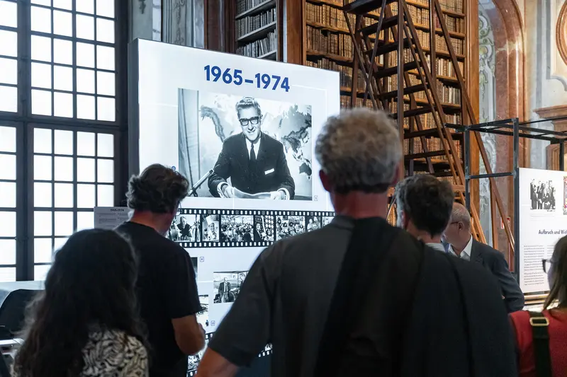 Visitors Examining 1965-1974 Historical Photography Exhibit at Austrian National Library
