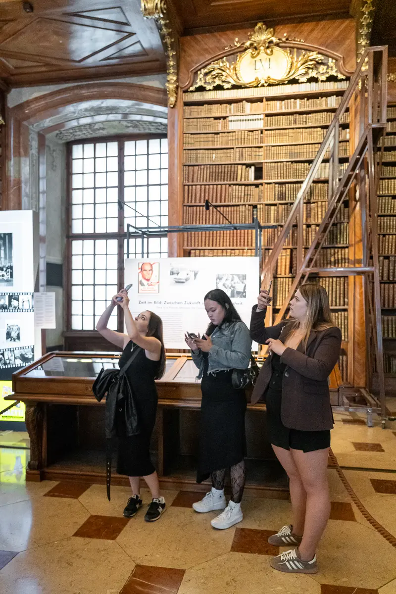 Visitors Exploring Austrian National Library's Centennial Photography Exhibition