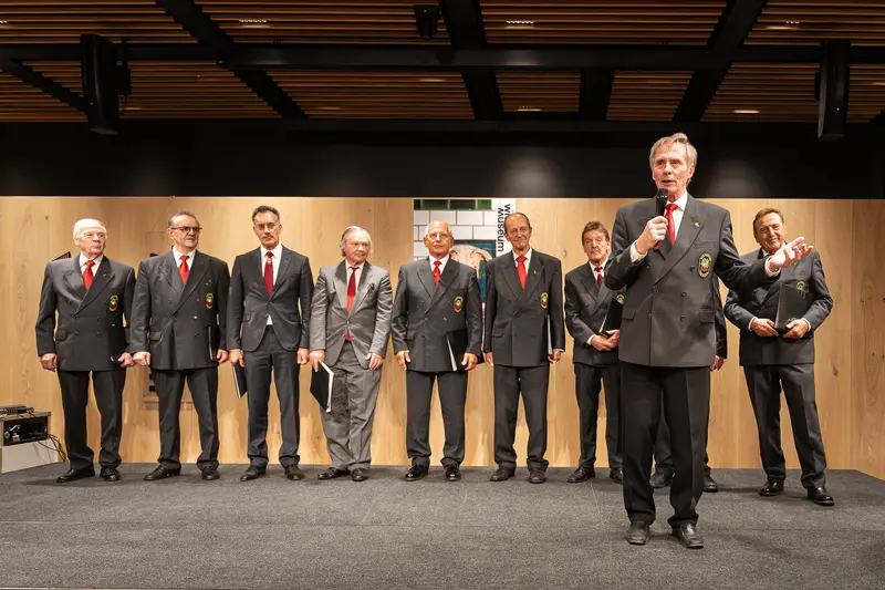 Distinguished Men in Gray Suits and Red Ties at Formal Gathering