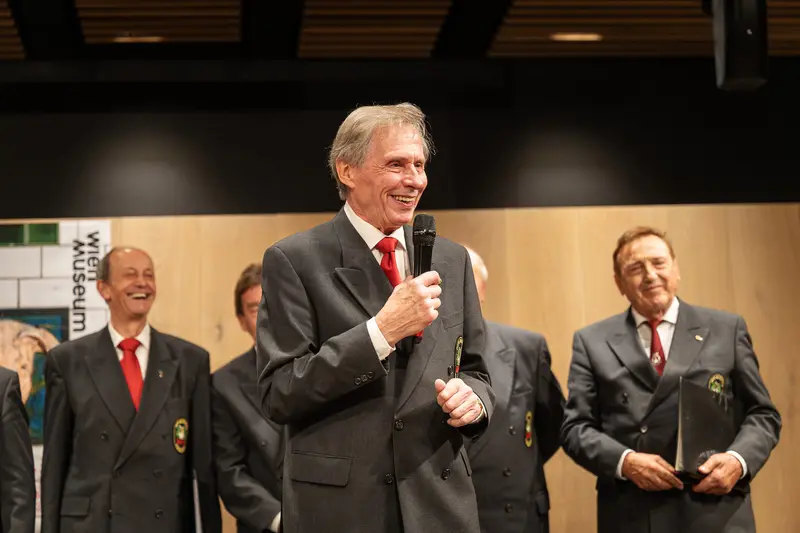 Vienna Museum Event Speakers in Dark Suits and Red Ties