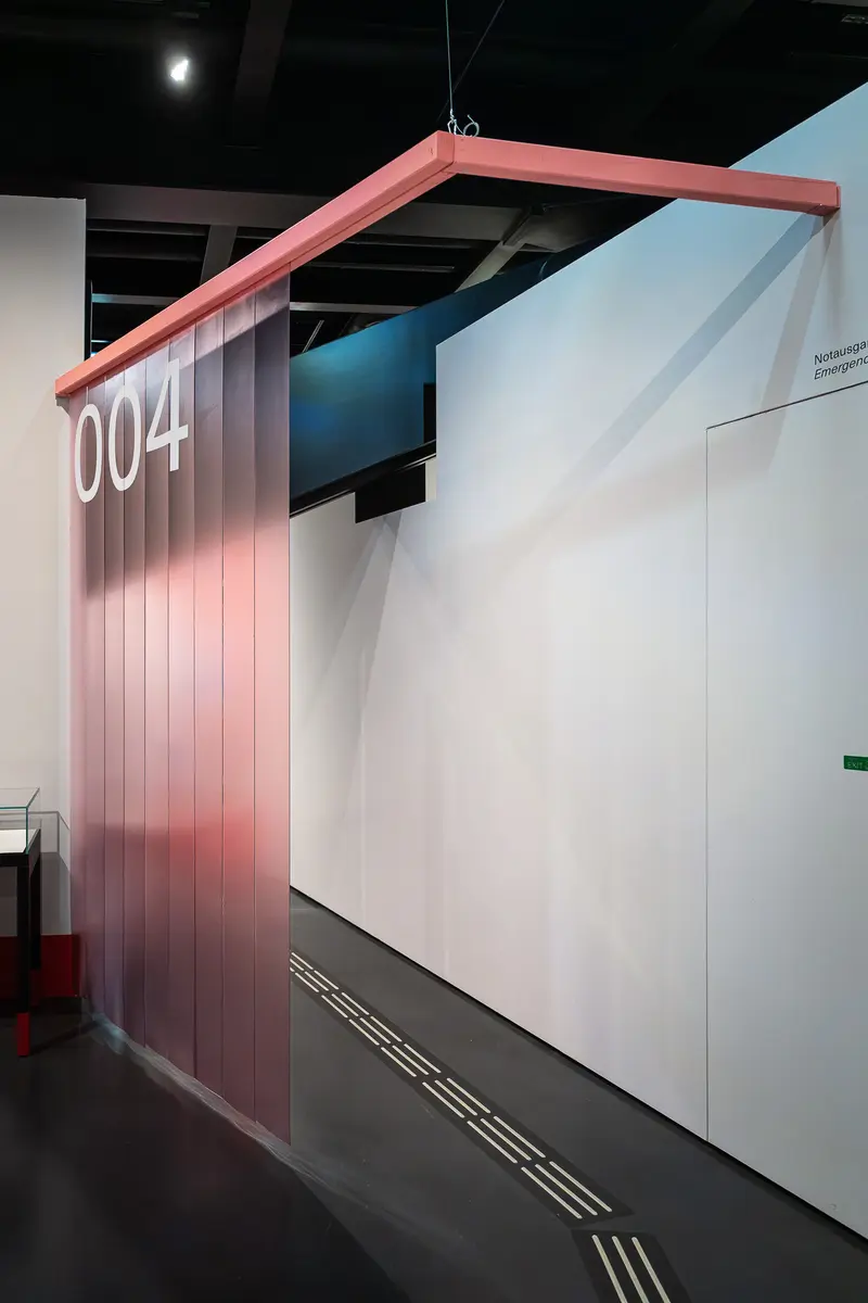 Architectural Interior with Pink Sliding Panel and Numeric Signage
