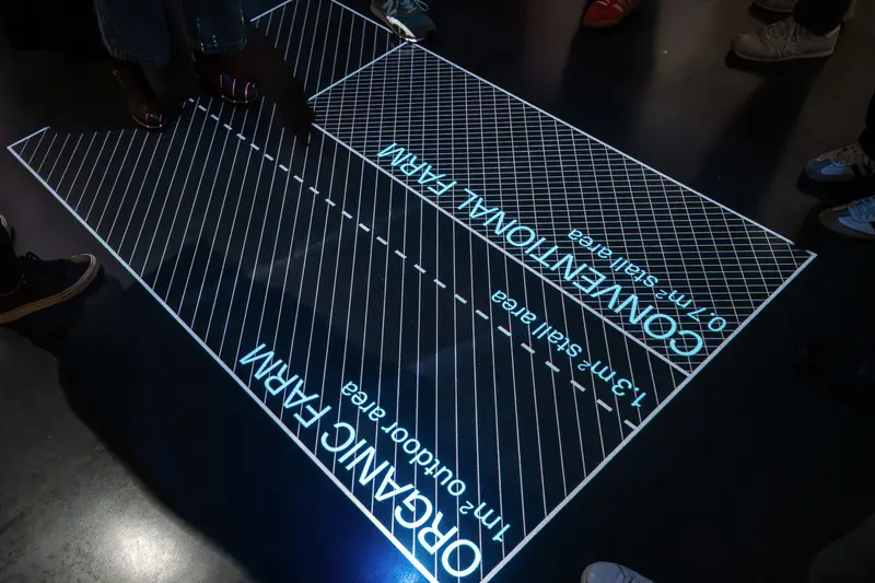 Illuminated Floor Display at Exhibition Design Event with Grid Patterns