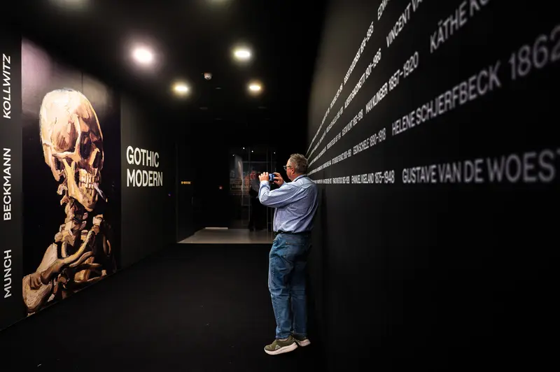 Gothic Modern Exhibition at Albertina: Visitor Examining Skull Artwork and Timeline
