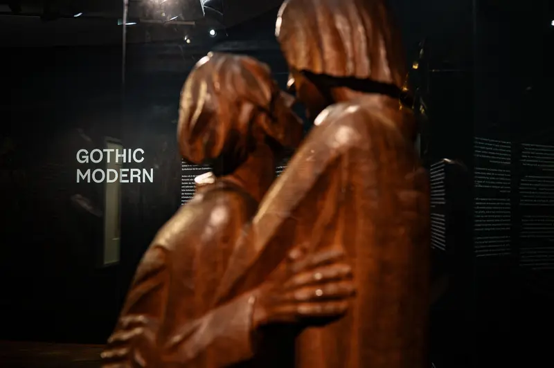Gothic Modern Exhibition: Wooden Sculpture Reflecting Intimate Human Connection