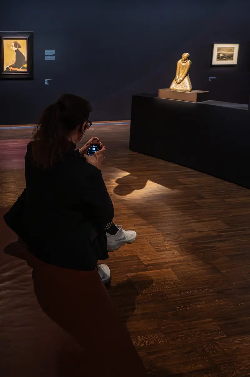 Visitor Studying Artwork at Gothic Modern Exhibition, Albertina Museum