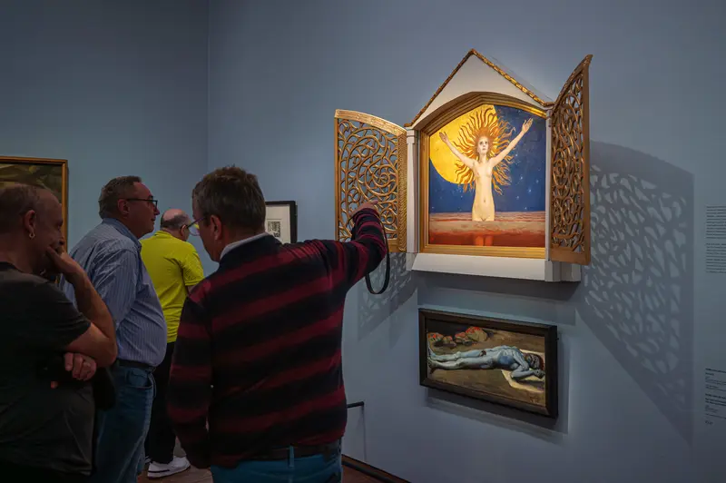 Visitors Examining Illuminated Artwork at Gothic Modern Exhibition, Albertina