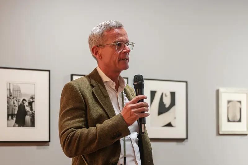 Art Gallery Curator Discusses Exhibition During Microphone Presentation