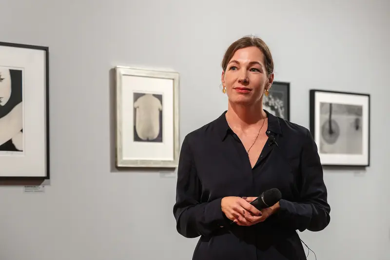 Art Gallery Curator Presenting Exhibition in Black during Photographic Display