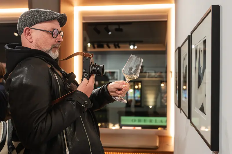 Wine Glass and Camera at Gallery Event - Photographer in Reflective Moment