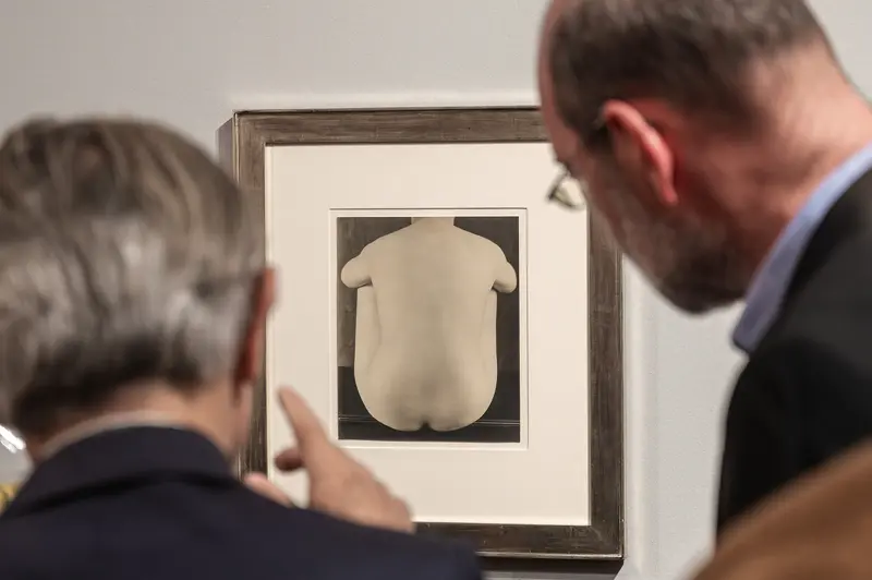Gallery Visitors Studying Minimalist Nude Photographic Art in Museum Exhibition