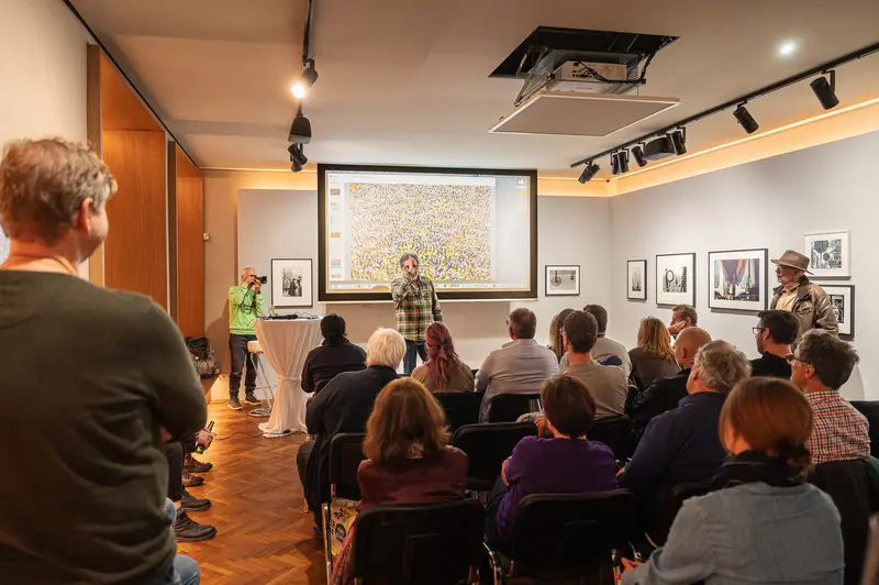 Hans-Jürgen Burkard at Leica Gallery Vienna. Hans-Jürgen Burkard Presenting to Audience at Leica Gallery Vienna, October 2025
