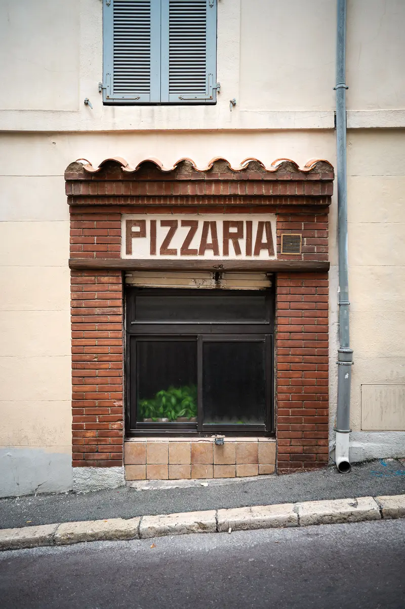Rustic Brick Pizzeria Storefront in Urban Street Setting