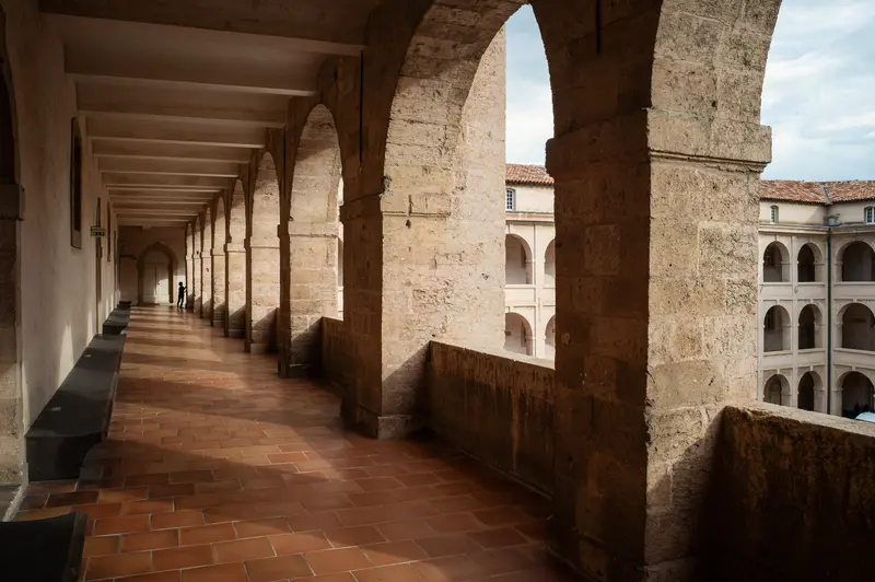 Stone Archways and Tiled Corridor in Historic Mediterranean Architectural Complex