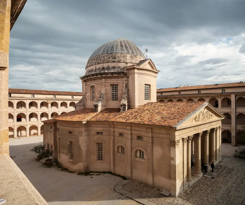 Neoclassical Domed Building in Historic Architectural Complex Under Cloudy Skies