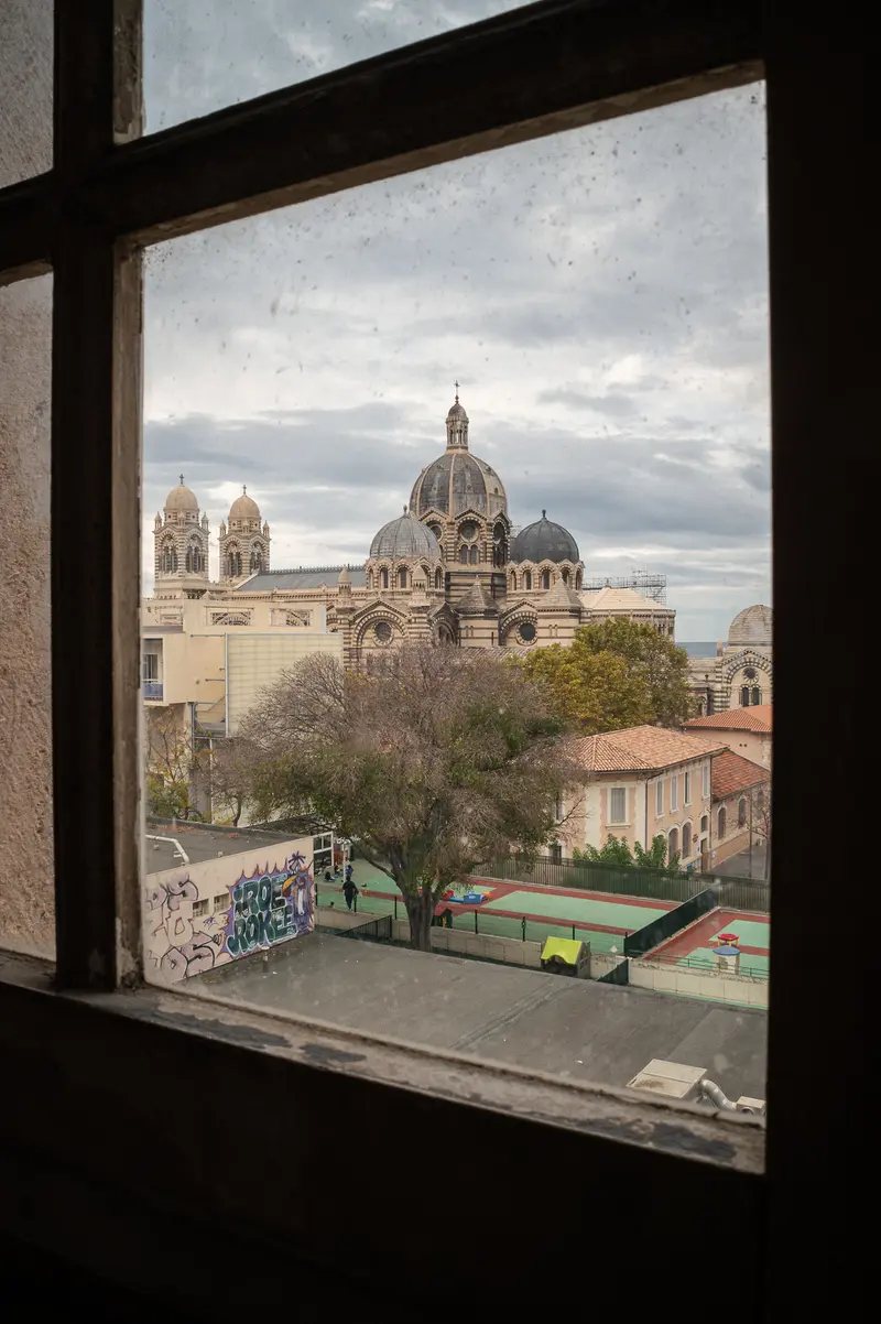 Marseille Cathedral Viewed Through Window Frame with Urban Landscape