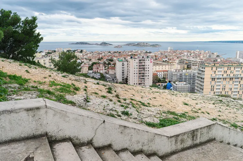 Marseille Cityscape from Rocky Hillside Overlooking Mediterranean Urban Landscape