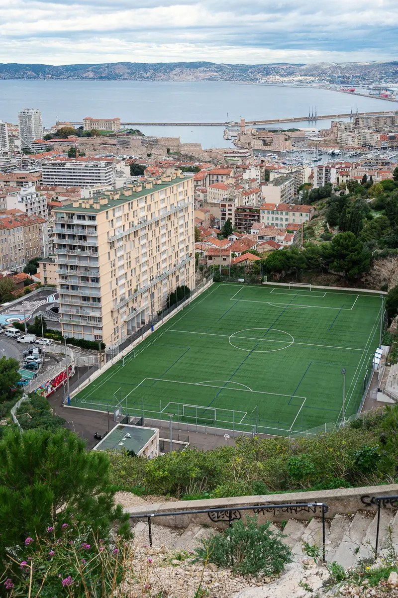 Urban Soccer Field Overlooking Marseille Harbor and Historic City Architecture