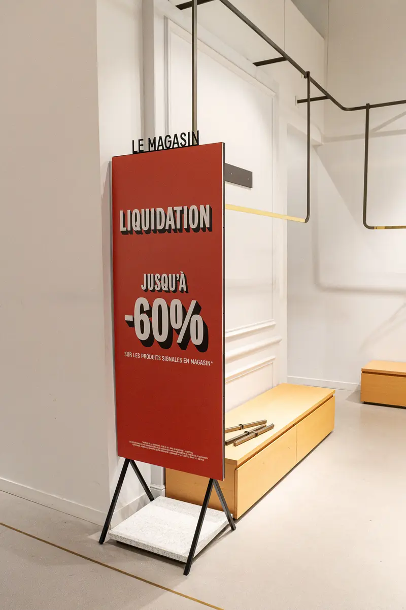 Liquidation Sale Sign Displaying Up to 60% Discount in Retail Space