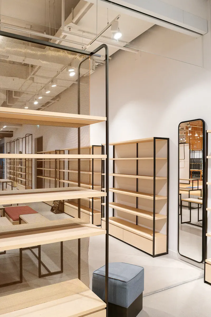 Modern Minimalist Retail Space with Wooden Shelving and Industrial Lighting