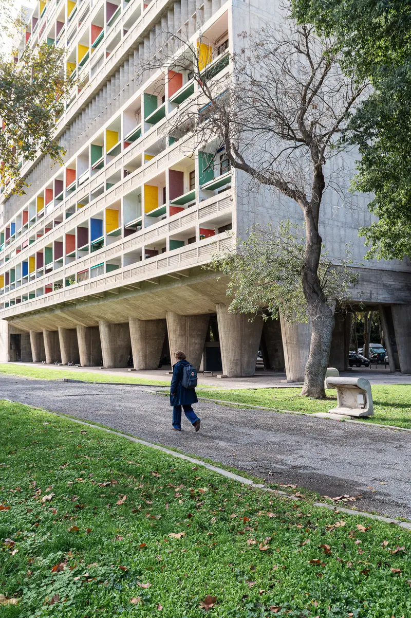 Modernist Concrete Building with Colorful Windows in Urban Setting
