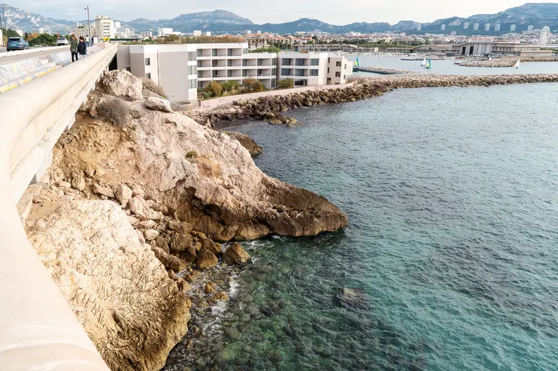 Rocky Coastline of Marseille with Modern Hotel and Mediterranean Seascape