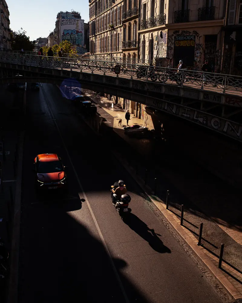 Motorcycle and Red Car on Marseille Urban Bridge at Sunset