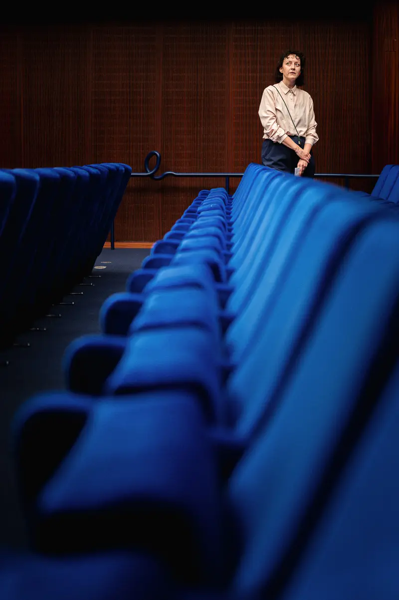 Solitary Figure in Blue-Seated Auditorium at Stadtkino