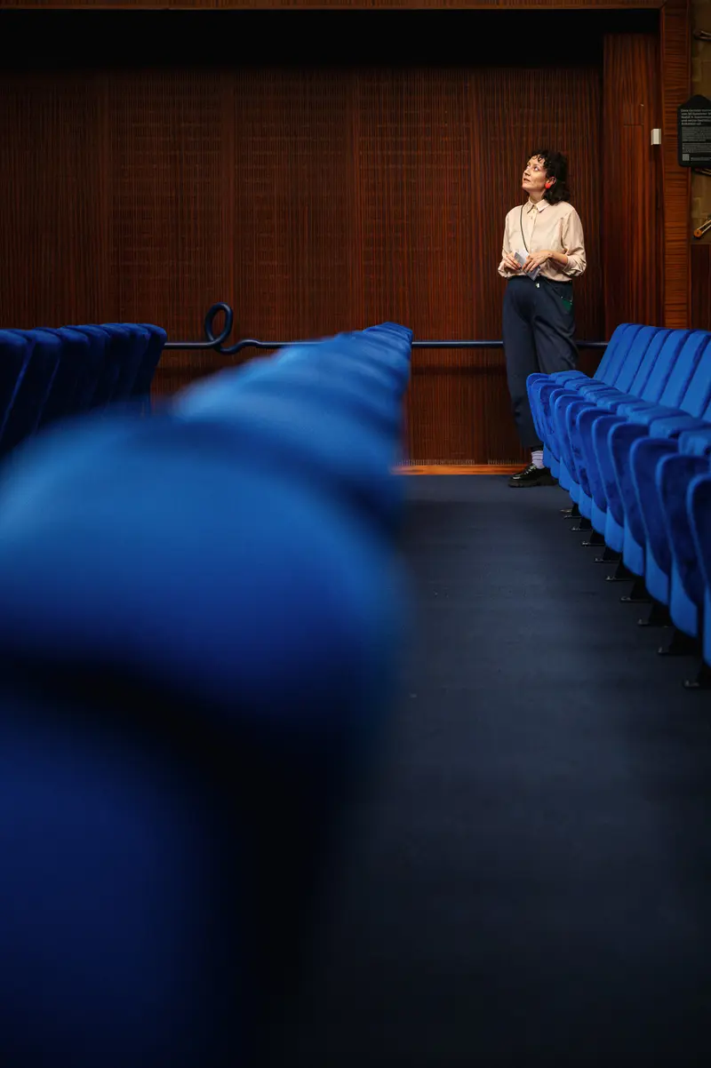 Solitary Figure in Blue Auditorium at City Cinema