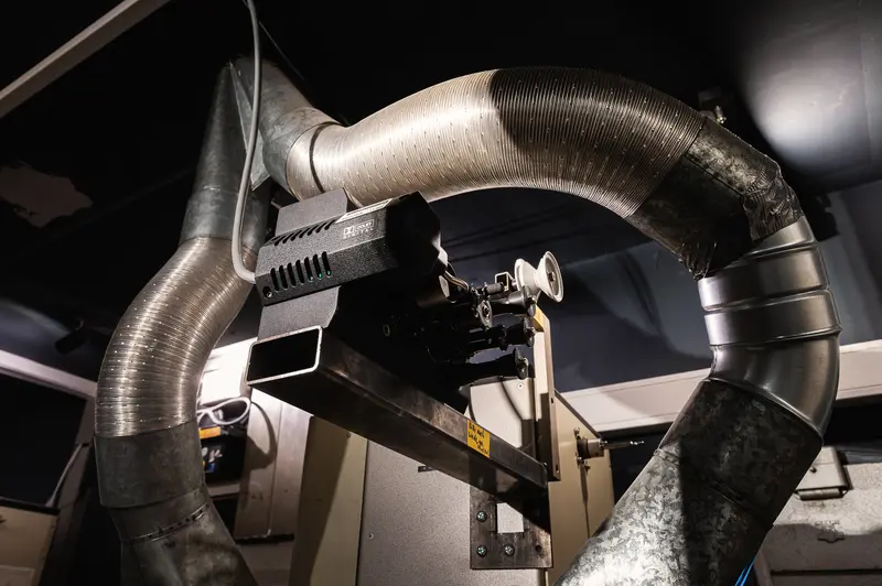 Industrial Ventilation System with Curved Metal Ductwork and Camera Mount