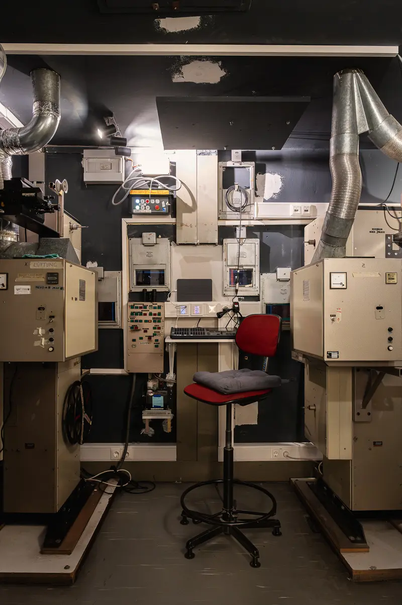 Industrial Control Room with Red Operator Chair and Complex Machinery