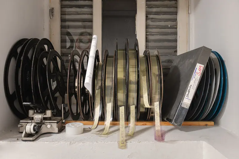 Vintage Film Reels and Projection Equipment in Archival Storage
