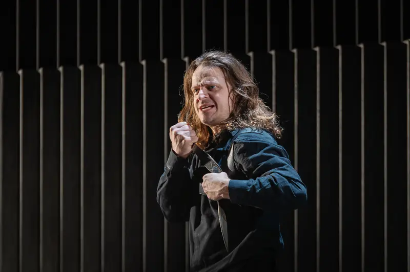 Hamlet Actor Portraying Intense Emotional Moment During Theater Production