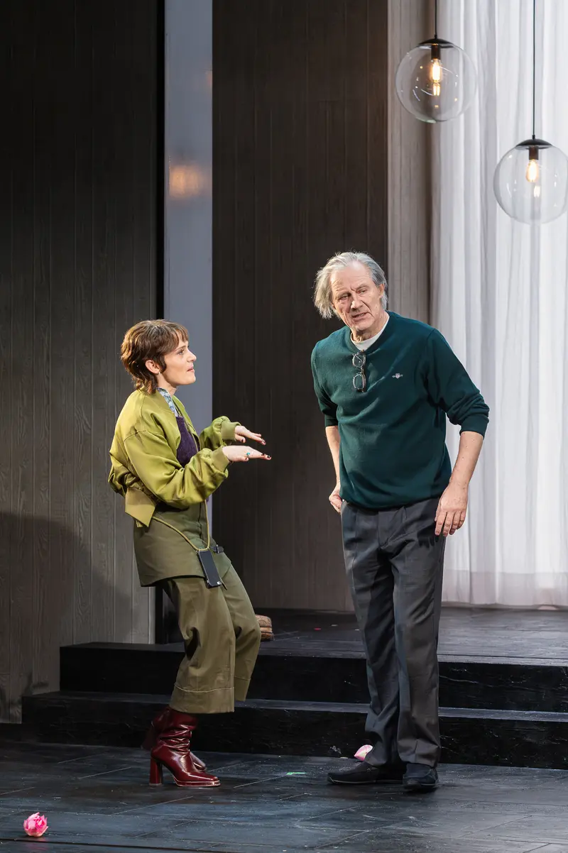 Two actors in conversation on stage at Kammerspiele der Josefstadt, Vienna