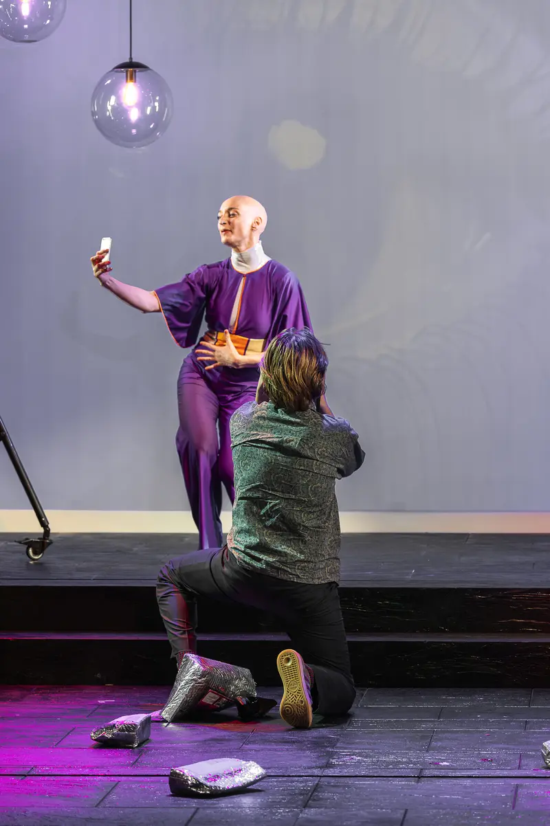 Actor in Purple Robe Takes Selfie During Performance at Kammerspiele der Josefstadt