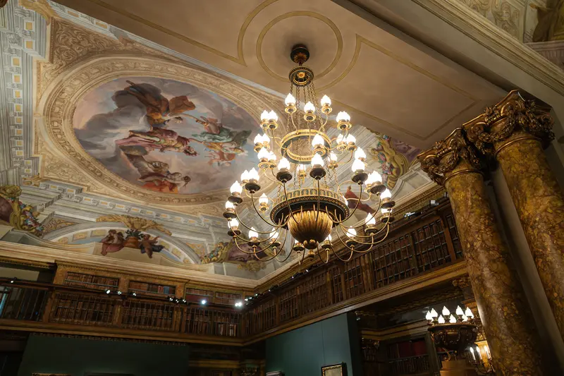 Ornate Ceiling with Cherub Fresco and Gilt Chandelier in Historic Library