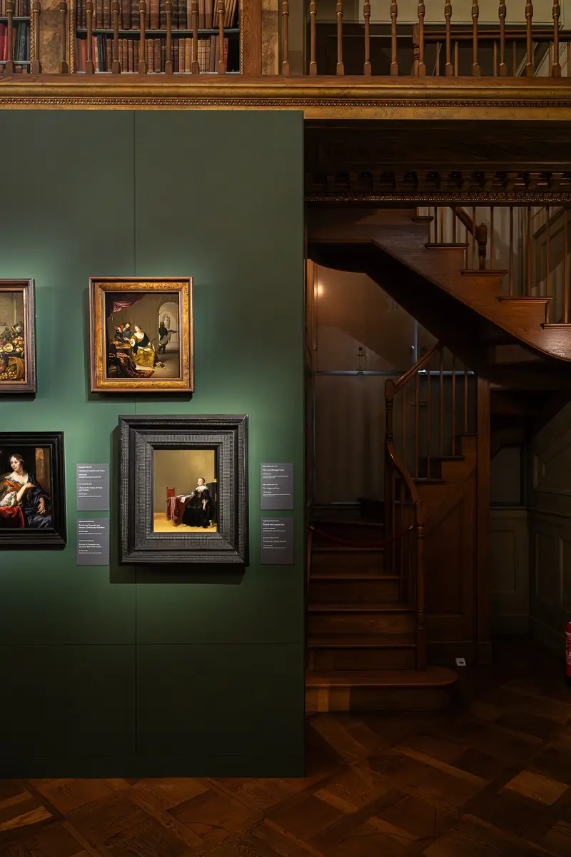 Green Gallery Wall with Old Master Paintings and Wooden Staircase