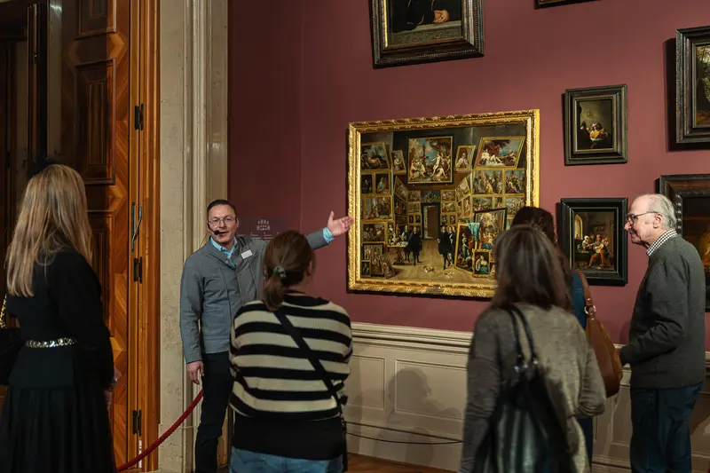 Museum Gallery Tour Guide Presenting Flemish Altarpiece to Visitors