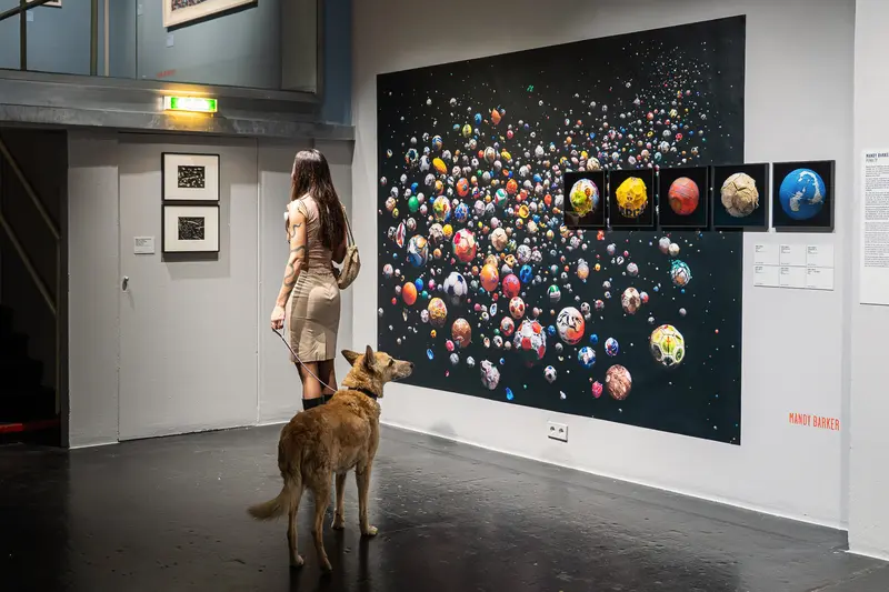 Visitor and Dog Viewing Cosmic Sphere Installation in Gallery Space
