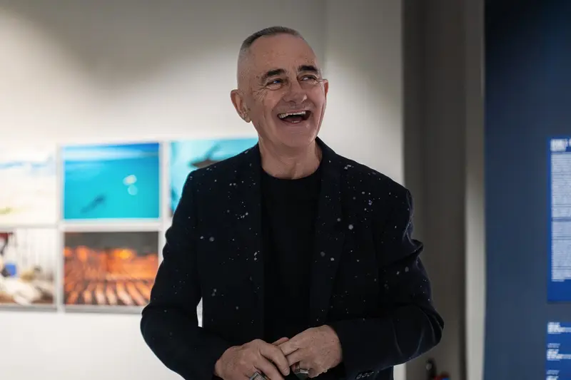 Man in Sequined Black Blazer Laughing at Gallery Opening