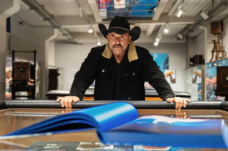 Michael Muller at Gallery Exhibition with Blue Sculptural Work