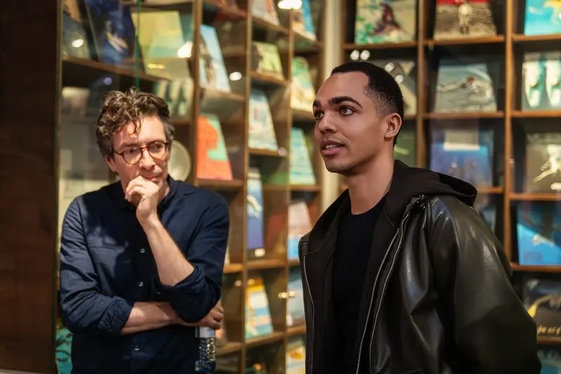 Two Men in Conversation at Library Exhibition Event
