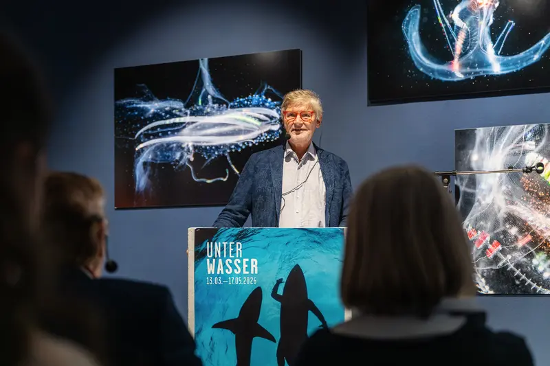 Presenter at Unter Wasser Exhibition Opening with Aquatic Photography Display