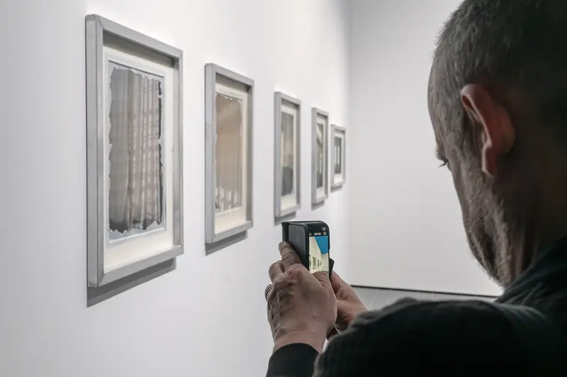Visitor Photographs Emma Hummerhielm Carlén's Framed Works at STRABAG ART Site Exhibition