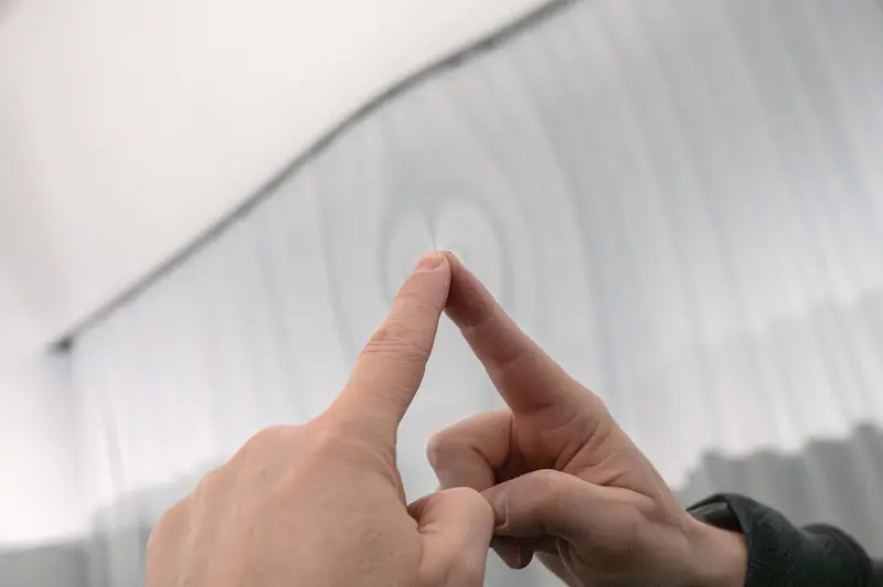 Visitor Forms Triangle Hand Gesture at Emma Hummerhielm Carlén Exhibition STRABAG ART Site