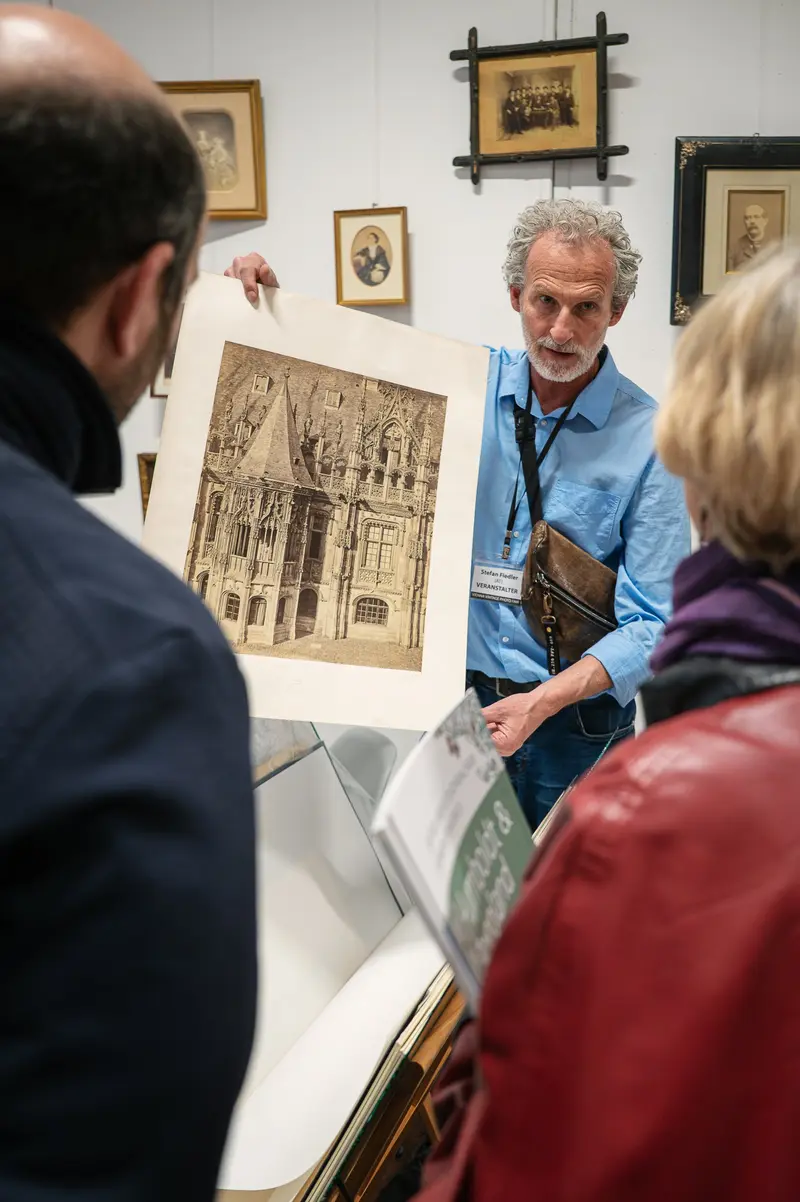 Museum Docent Presenting Architectural Drawing to Gallery Visitors