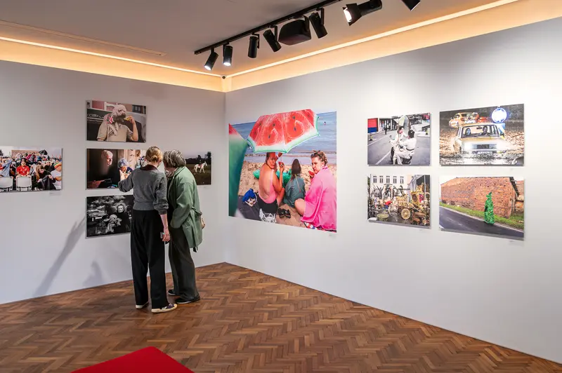 Exhibition visitors view 15th Street Photo Contest at Leica Gallery Vienna
