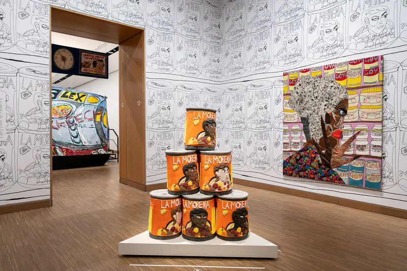 Installation view with stacked La Morena cans and collage portrait, Albertina Modern Vienna